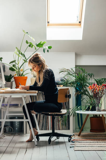 istock Beautiful Female Student Writing Notes at Home 1337645307