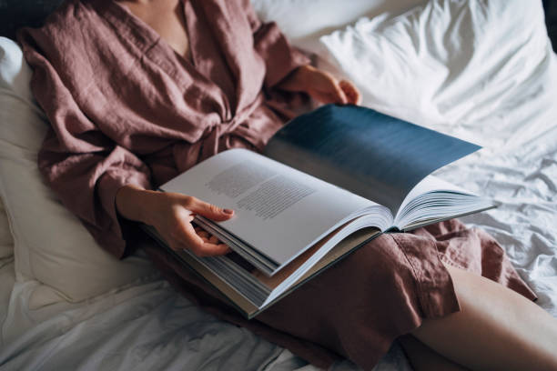 istock An Anonymous Woman Reading a Book in her Bed 1337645897
