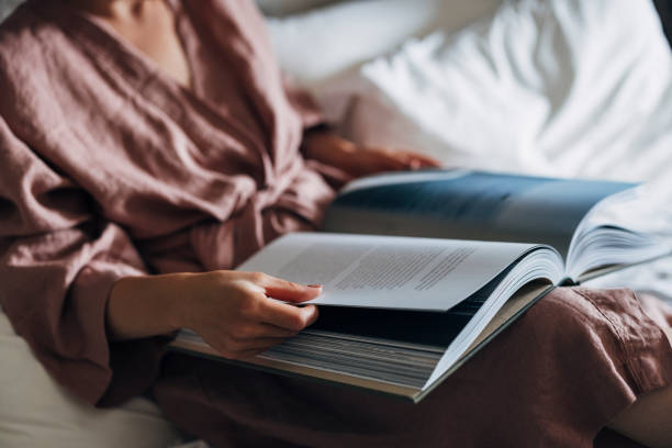 istock An Anonymous Woman Reading a Book in her Bed 1337645899
