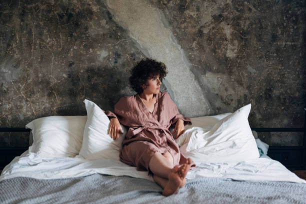 istock Relaxed Woman Sitting in Bed at Home 1337645903