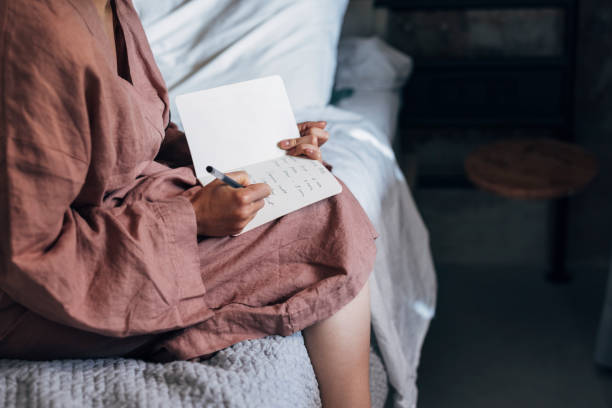 istock An Anonymous Woman Writing Notes in Bed at Home 1337645920