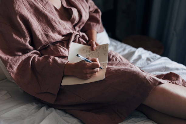 istock An Anonymous Woman Writing Notes in Bed at Home 1337645932