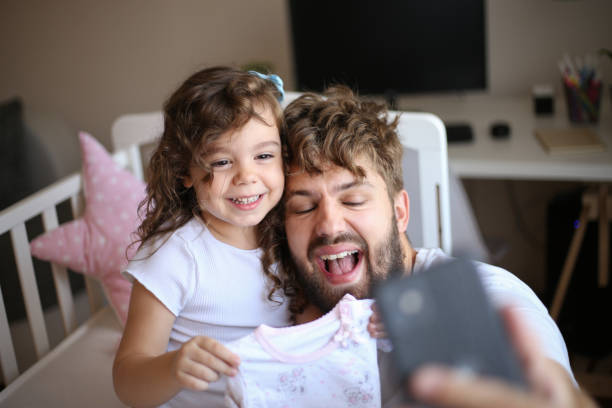 We have to be prepared stock photo Father and daughter preparing room for newborn man with teddy bear stock pictures, royalty-free photos & images