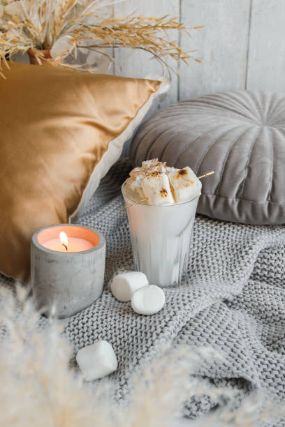 cozy marshmallow milkshake on sofa with candle