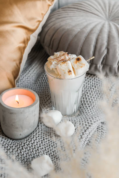 istock cozy marshmallow milkshake on sofa with candle 1337650473