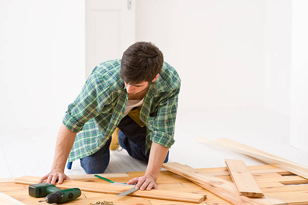 istock Home improvement - handyman installing wooden floor 133765061