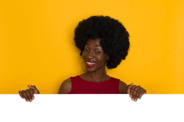 istock Smiling Black Young Woman Holding White Banner 1337651042