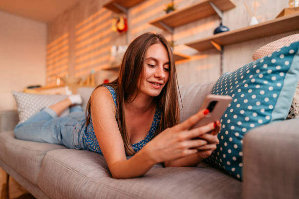 istock Woman checking social media on smart phone at home 1337654621