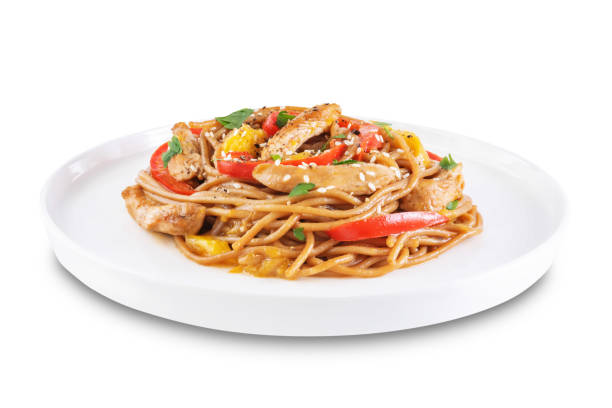 istock Buckwheat pasta with chicken, mango and red pepper in a plate on a white isolated background 1337655857