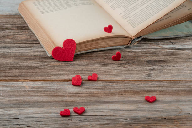 istock an old book opened on a wooden table decorated with red hearts 1337655980