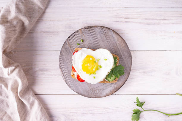 istock heart shaped egg sandwich on wooden board 1337657182