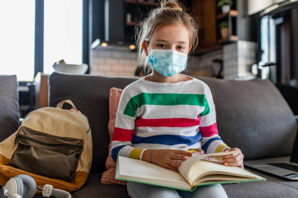 istock Schoolgirl at home, wearing a face mask 1337658392