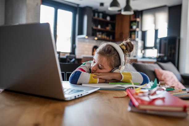 istock Cute girl fell asleep during online classes 1337658625