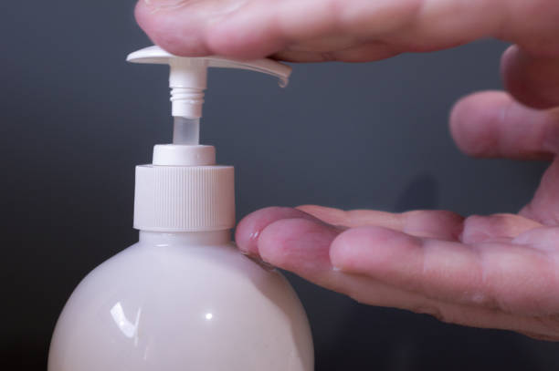 istock Man hands pouring hydroalcoholic gel from white bottle with grey background 2 1337660506
