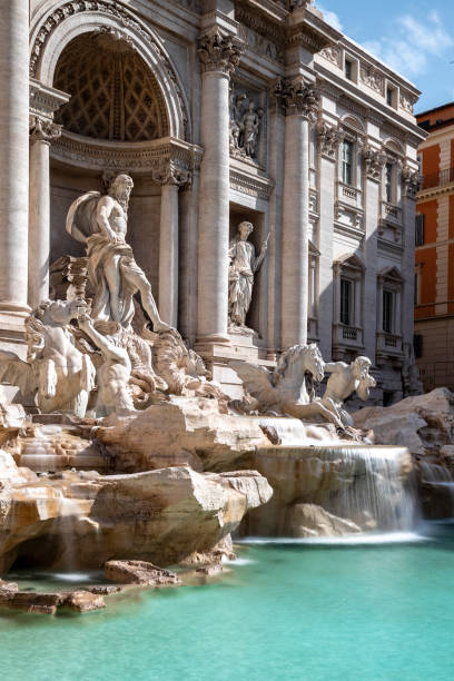famous trevi fountain in rome with flowing water stock photo