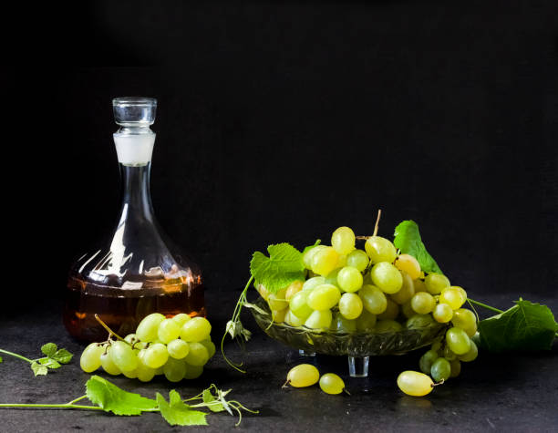 istock Fresh ripe grapes and decanter with grape juice on black background 1337667516