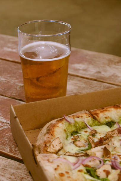 istock Front vertical plane of pizza with beer 1337668116