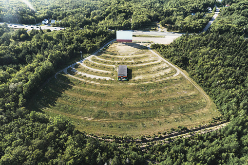 Aerial drone view of an abandoned drive in movie theatre.