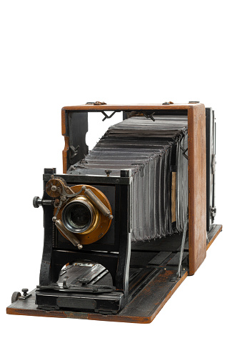 Vertical angled shot of a very early antique 8x10 glass plate camera manufactured by Folmer and Schwing 120 years old isolated on white.