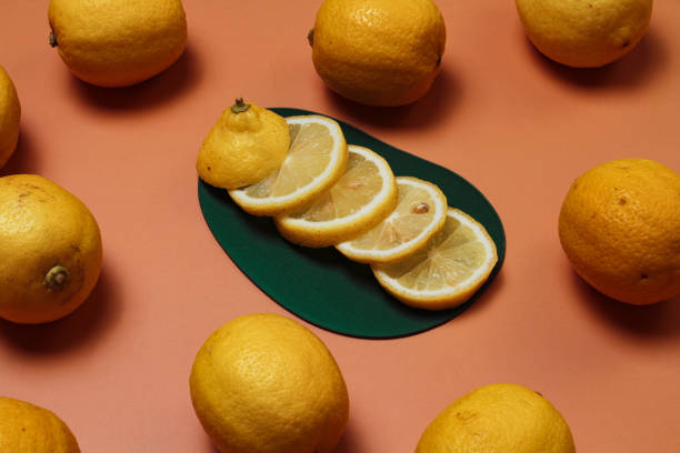 istock A bunch of fresh sliced and whole lemons on a peach colored background 1337674892