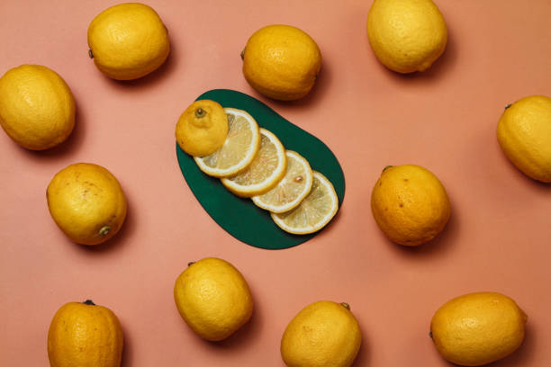 istock A bunch of fresh sliced and whole lemons on a peach colored background 1337674903