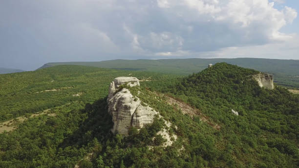 istock A steep cliff. A steep rocky mountain against a clear sky. A mountain peak. 1337678567