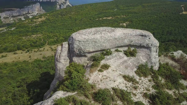 istock A steep cliff. A steep rocky mountain against a clear sky. A mountain peak. 1337678586