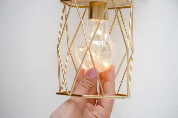 istock power from a light bulb on the ceiling and power outlet. 1337683346