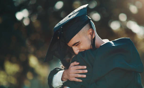 istock Shot of two students sharing a hug on graduation day 1337694777