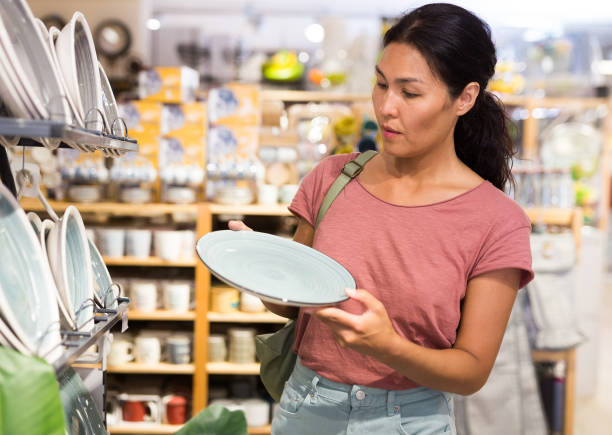 istock Asian woman choosing dishes at decor store 1337694963