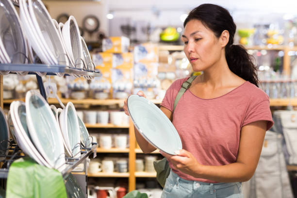 istock Asian woman choosing dishes at decor store 1337694965