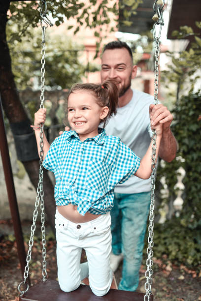 istock Quality Time Spend By Dad And Daughter On Playground Swing 1337695151
