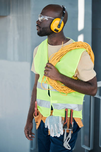istock Full length portrait of construction worker standing in elevator and speaking by walkie-talkie giving instructions to crew on site, copy space 1337699862