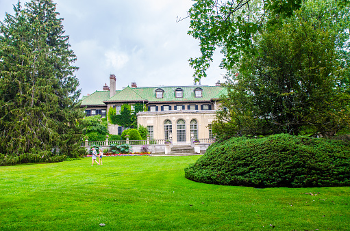 Rear view of Parkwood Estate Mansion during summer day\n\nThe Parkwood Estate, located in Oshawa, Ontario, was the residence of Samuel McLaughlin (founder of General Motors of Canada) and was home to the McLaughlin family from 1917 until 1972. Parkwood was officially designated a National Historic Site in 1989.