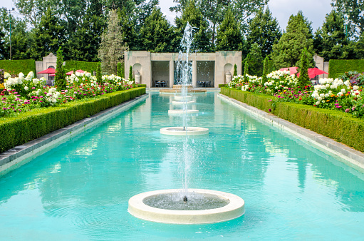 Huge fountain at the Parkwood Estate during summer day\n\nThe Parkwood Estate, located in Oshawa, Ontario, was the residence of Samuel McLaughlin (founder of General Motors of Canada) and was home to the McLaughlin family from 1917 until 1972. Parkwood was officially designated a National Historic Site in 1989.
