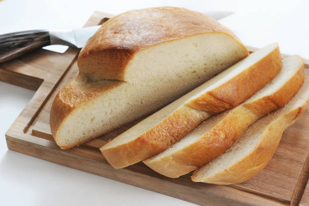 istock round bread cut into slices on a wooden board with a knife 1337703115