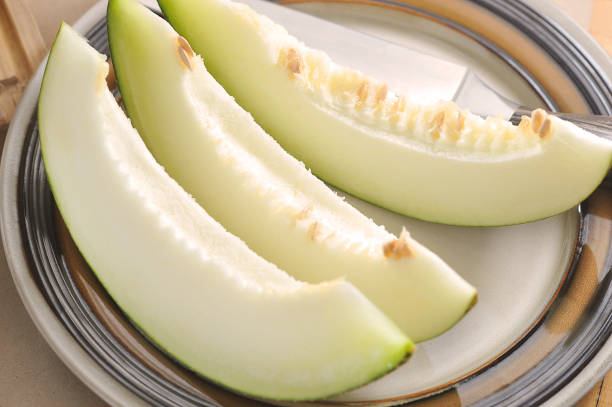 istock melon slices on a plate and a knife 1337703642