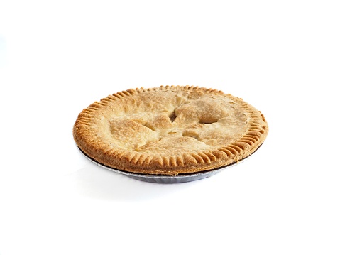 Apple pie on white background. Apple pie in aluminum pie plate with flakey crust on white background. Shadows shown on white.