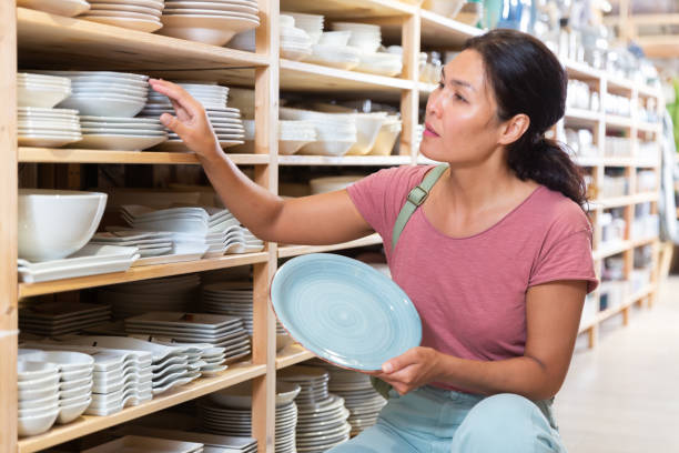 istock Asian woman choosing dishes at decor store 1337705585