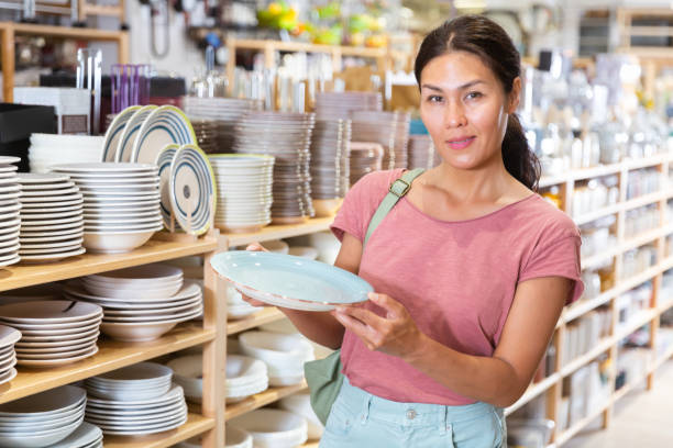 istock Asian woman choosing dishes at decor store 1337705625