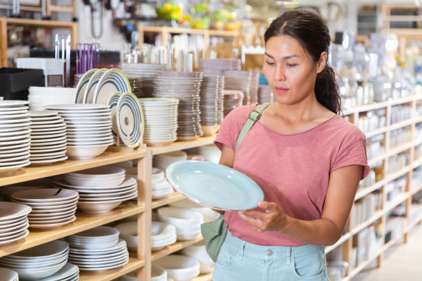 istock Asian woman choosing dishes at decor store 1337705645