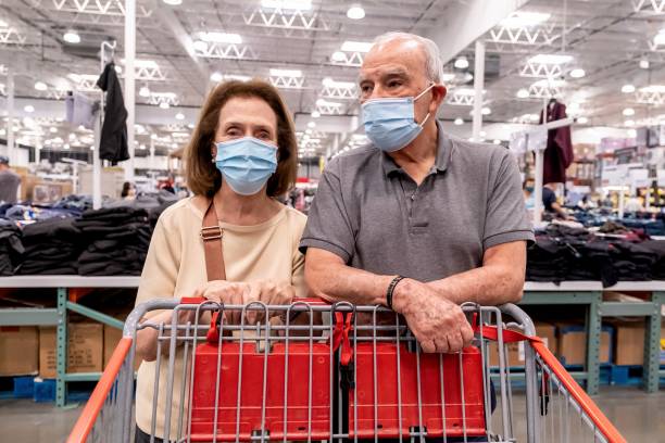 istock senior couple shopping wearing protective face masks 1337707703