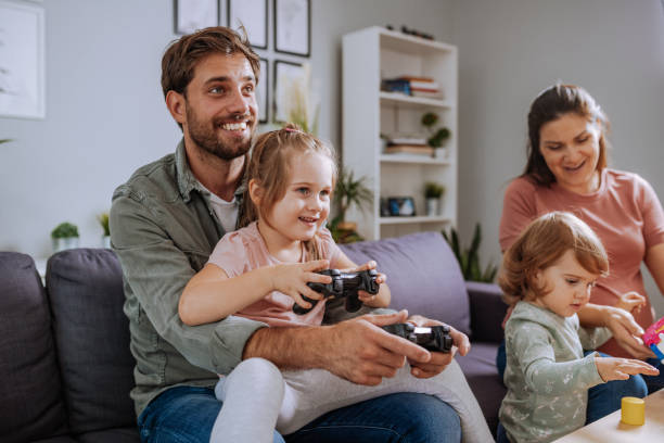 istock Family at home having fun, playing video game and using wireless joysticks 1337708824