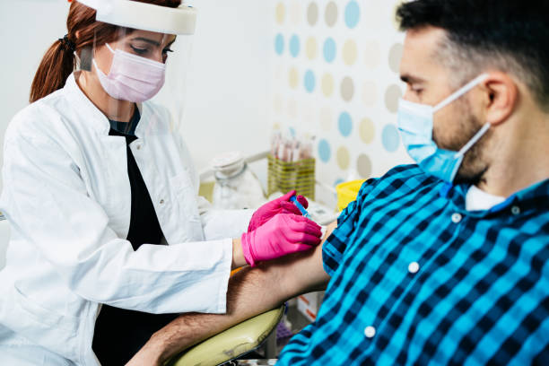 istock Mature man taking a vaccine from his doctor 1337710972