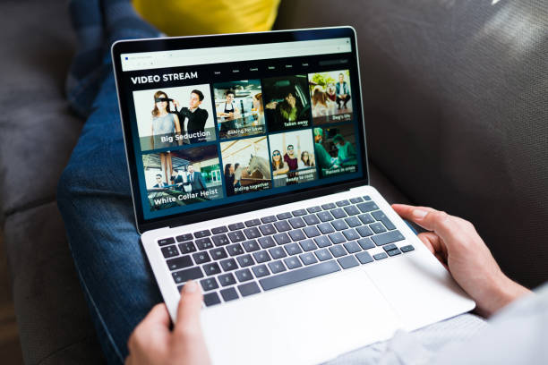 istock Person browsing for a movie on the couch 1337712617