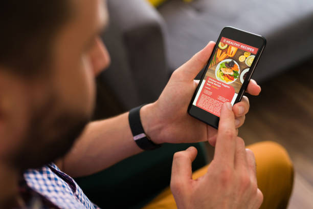 istock Man reading a delicious recipe on the phone 1337713407