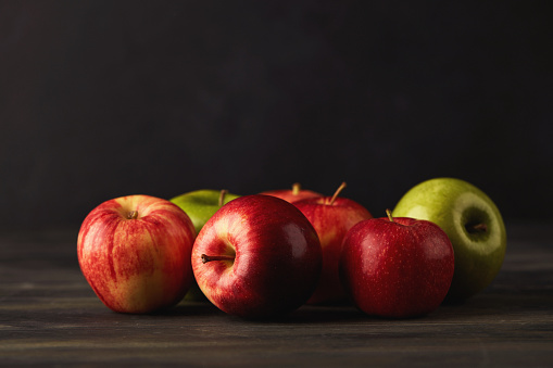 Still Life of Assorted Apple Varieties in Dark Setting