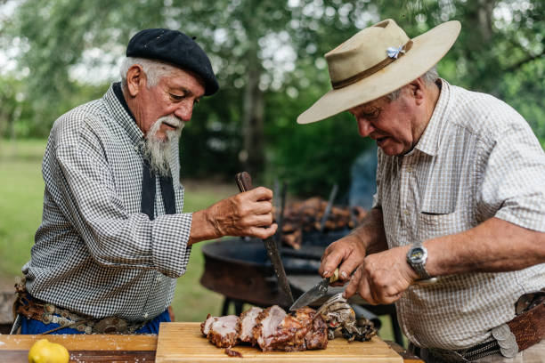 Gauchos cutting meat in the countryside