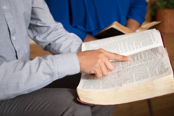 Bible Study.   Multi Ethnic Group.
Multi Ethnic Group of friends meet for a Bible Study.  Group includes teenager, young adults, mid-adults and senior adult.  Close up of Bibles. stock photo
