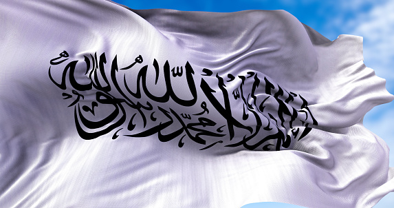 The flag of the Islamic Emirate of Afghanistan waving in the wind. It is an unrecognized Islamic emirate that was established by taliban in August 2021 with the fall of Kabul
